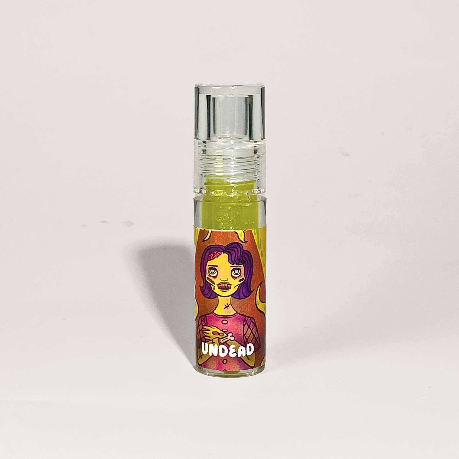 Small glass bottle with colorful label featuring a character on a light gray background